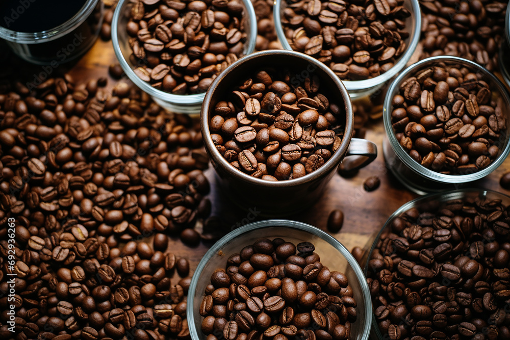 Fototapeta premium Spilled Coffee Beans on a wooden table, Studio Background Lighting