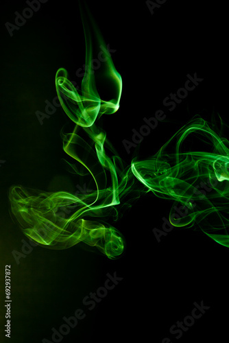 Green smoke motion on black background.