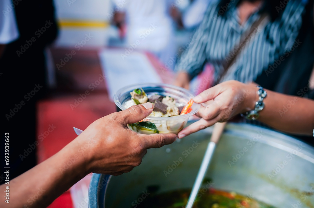 concept of charity food for the poor : the concept of life problems, hunger in society : Helping People With Hunger With Kindness : The hands of beggars receive donated food concept of charity food for the poor : the concept of life problems, hunger in society : Helping People With Hunger With Kindness : The hands of beggars receive donated food