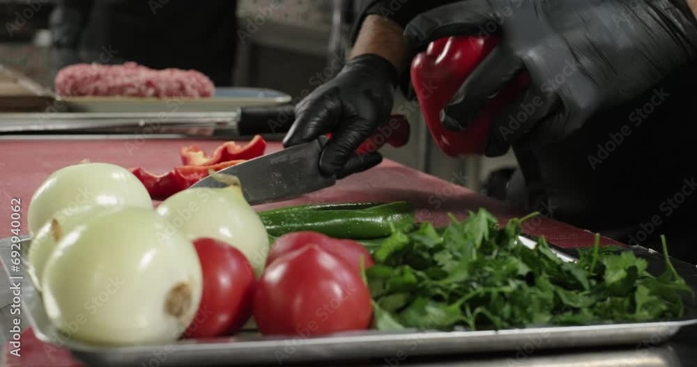 Chef's hands cutting fresh red bell pepper with knife. Healthy lifestyle food Chef's hands cutting fresh red bell pepper with knife. Healthy lifestyle food