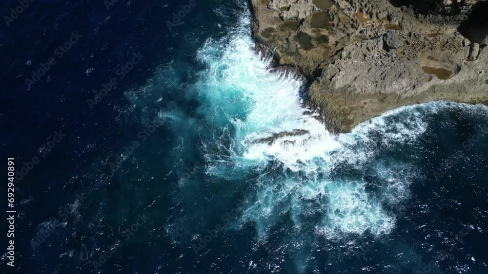 Crashing and spiralling waves off the coast of Nusa Penida Island, Indonesia in the summer. Aerial. Crashing and spiralling waves off the coast of Nusa Penida Island, Indonesia in the summer. Aerial.