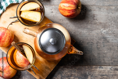 Autumn hot apple drink with spices on wooden table. Top view. Copy space