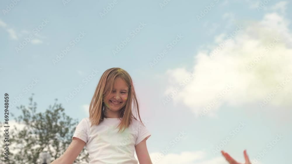 cute little girl playing with a holi powder throwing a colorful powder up, celebrating at Holi Festival cute little girl playing with a holi powder throwing a colorful powder up, celebrating at Holi Festival