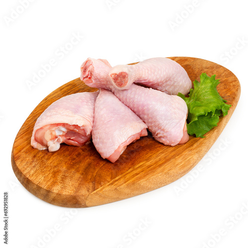 Chicken drumstick fresh on a wooden board, on a white background, isolated