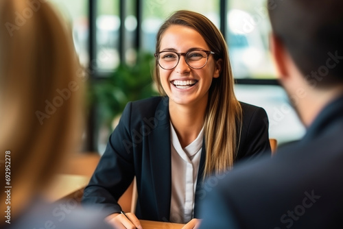 Businesswoman in Job Interview: Recruitment Meeting with Smiling HR Managers photo