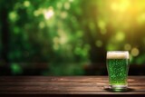 Patrick Day green beer on empty wooden table top and blurred green background in pub. Festive traditional beverage.