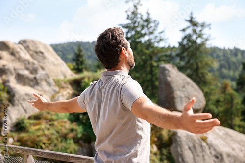 Feeling freedom. Man with wide open arms in mountains