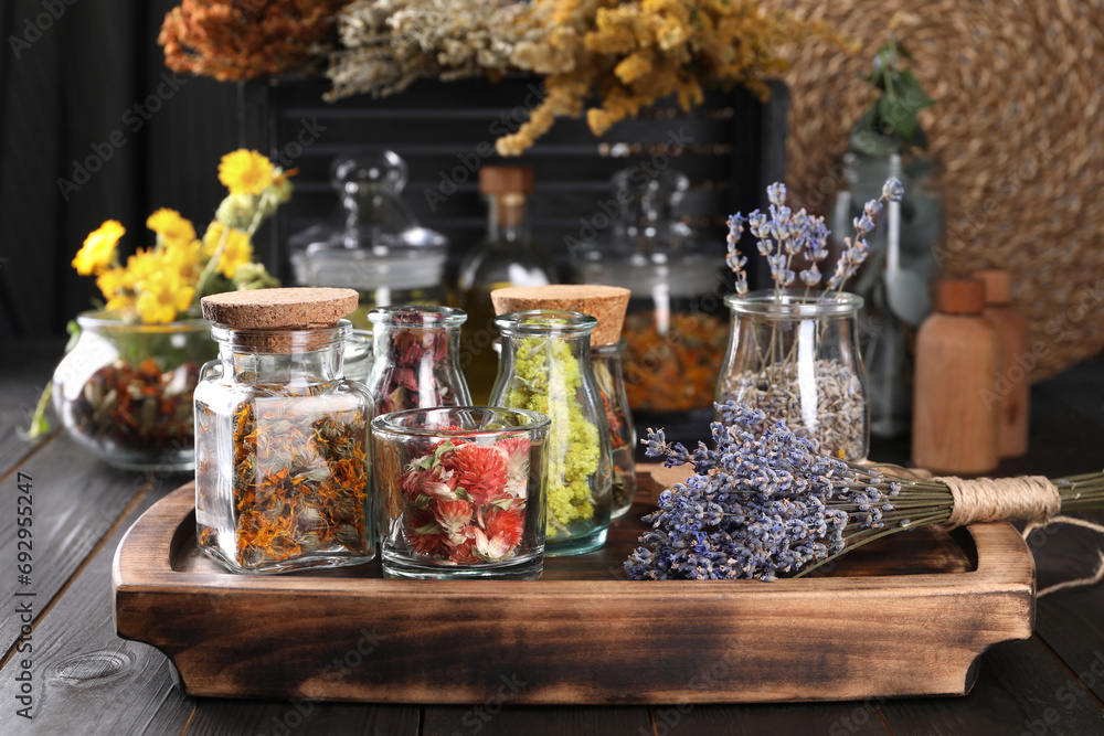 Many different herbs and dry lavender flowers on wooden table