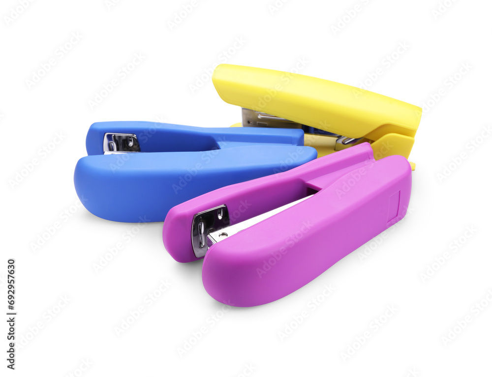 Many new bright staplers isolated on white Many new bright staplers isolated on white
