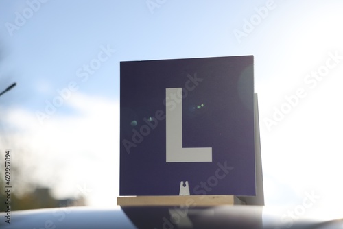 L-plate on car roof outdoors. Driving school