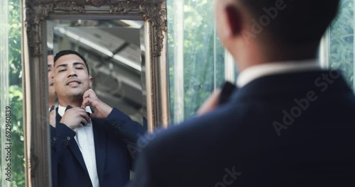 Mirror, wedding or groom with fashion, marriage or confidence for ceremony, love or celebration. Person, gentleman or happy man with a suit, bow tie or pride ready for event with smile or reflection photo