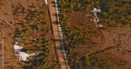 Aerial landscape view of gravel road in forest in spring, Sodankylä, Lapland, Finland. photo