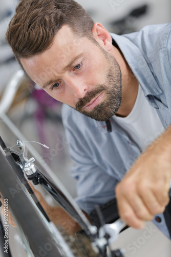 man repairing bicycle at home