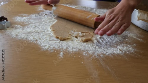 Preparing Christmas cookies, hands, making dough, baking.