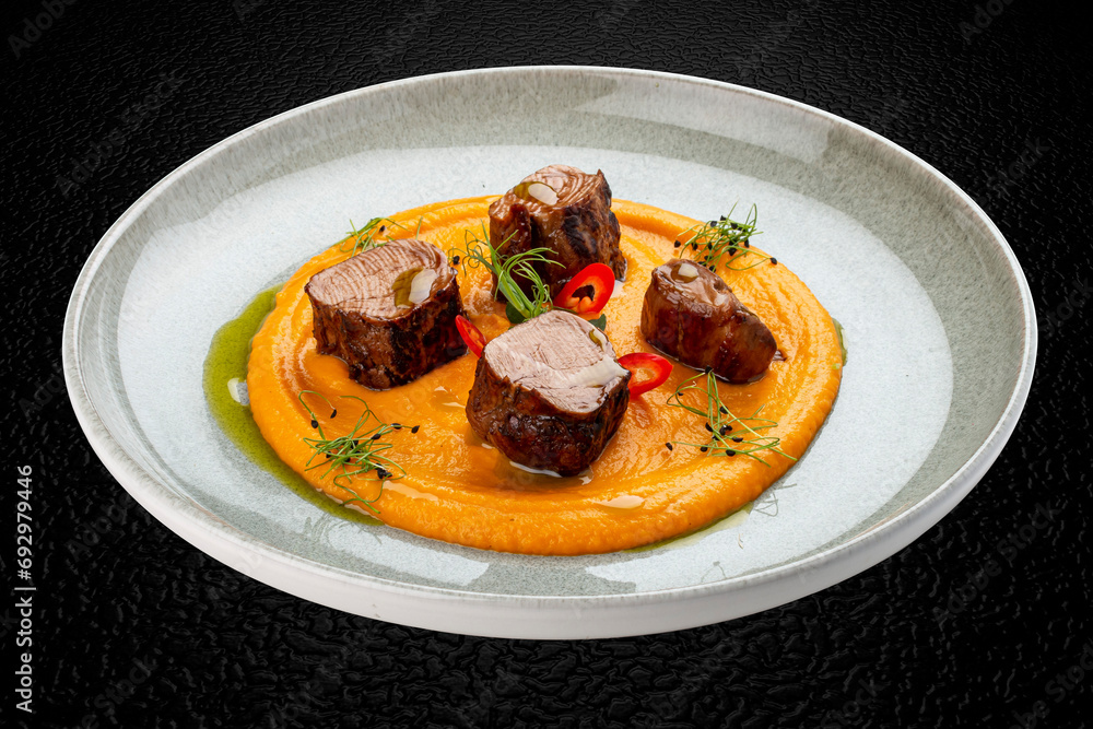 Pork loin on mashed yams. Isolated image Pork loin on mashed yams. Isolated image
