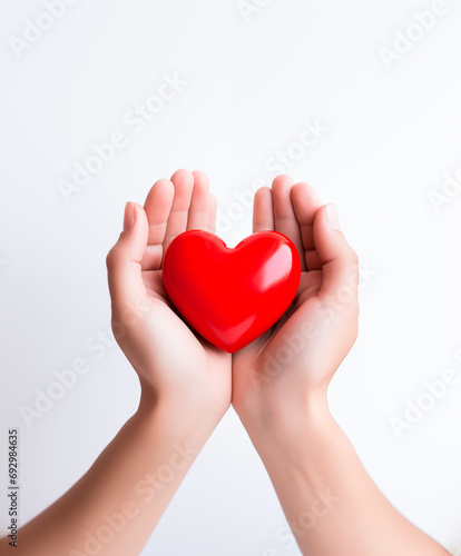 Hands cradling red heart  symbol of care and love. Valentines Day concept. Copy space. 