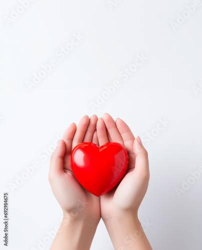 Hands cradling red heart  symbol of care and love. Valentines Day concept. Copy space. 