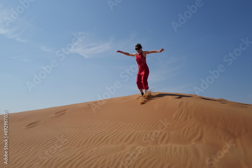Woman in red dress on sand dunes © akoppo1
