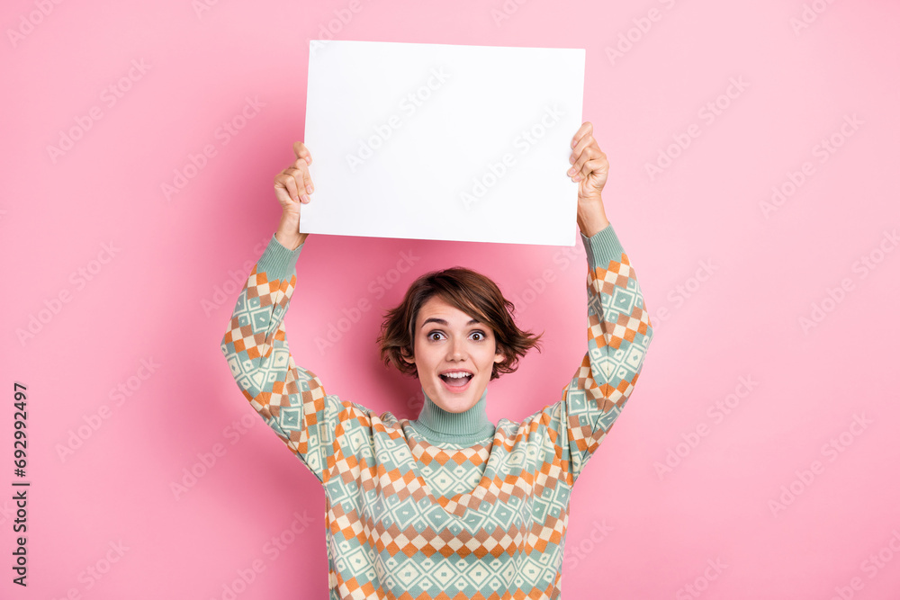 Photo of funky young lady astonished holding paper small placard mockup promoting wishlist shopping isolated on pink color background - obrazy, fototapety, plakaty 