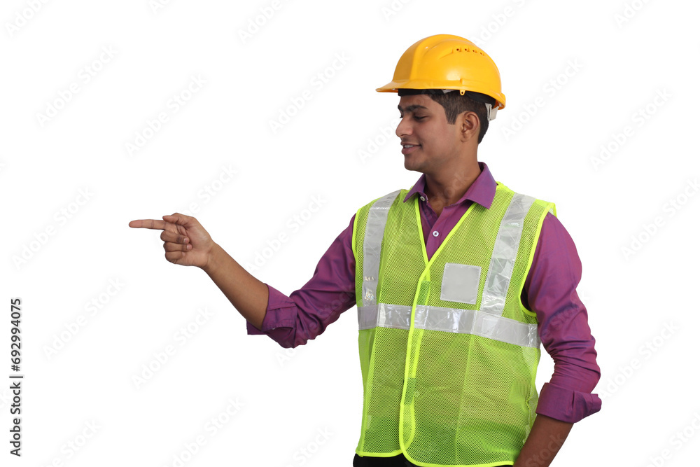 Indian male architect wearing yellow helmet and safety jacket pointing aside on white background Indian male architect wearing yellow helmet and safety jacket pointing aside on white background