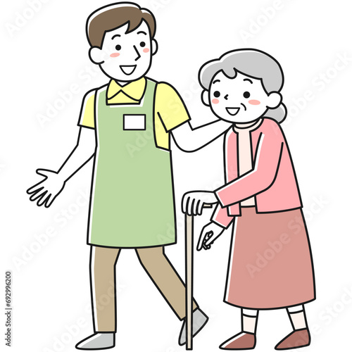 杖をついて歩くシニア女性と付き添う介護職員