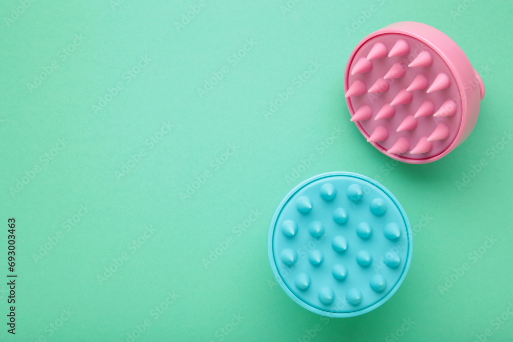 Brush for hair growth stimulating brush. Massage brush on mint background. Space for text Brush for hair growth stimulating brush. Massage brush on mint background. Space for text