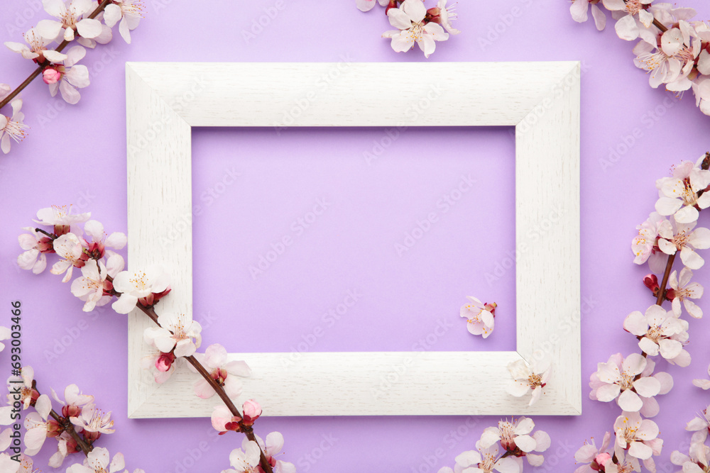 Spring flowers frame on purple background. Spring season, Nature floral background.