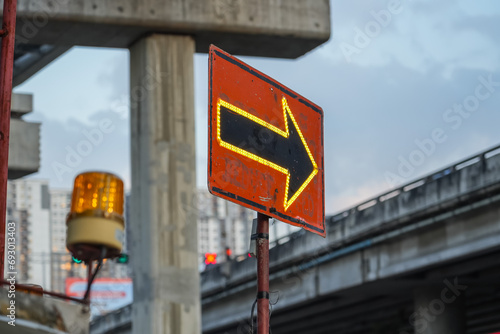 Traffic sign with flags reading utilitary. Electronic arrow pointing to the right to divert traffic. photo