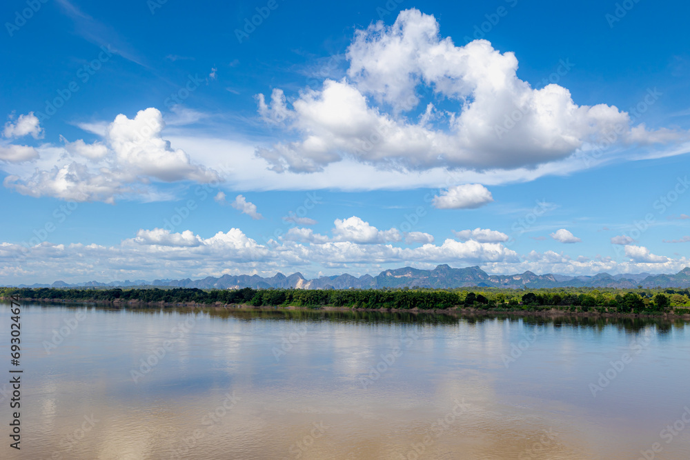 Landscape view of Laos along Mekong river, Big mountain, small villages and forest, Riverside between Thai and Laos border with blue sky, Nakhon Phanom province, Northeastern Thailand also called Isan