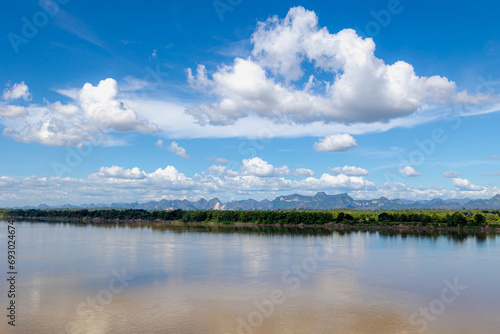 Landscape view of Laos along Mekong river, Big mountain, small villages and forest, Riverside between Thai and Laos border with blue sky, Nakhon Phanom province, Northeastern Thailand also called Isan