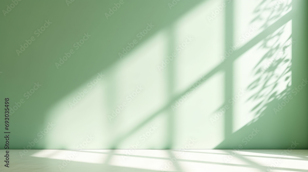 Minimal abstract light green background for product presentation. Shadow and light from windows on plaster wall.