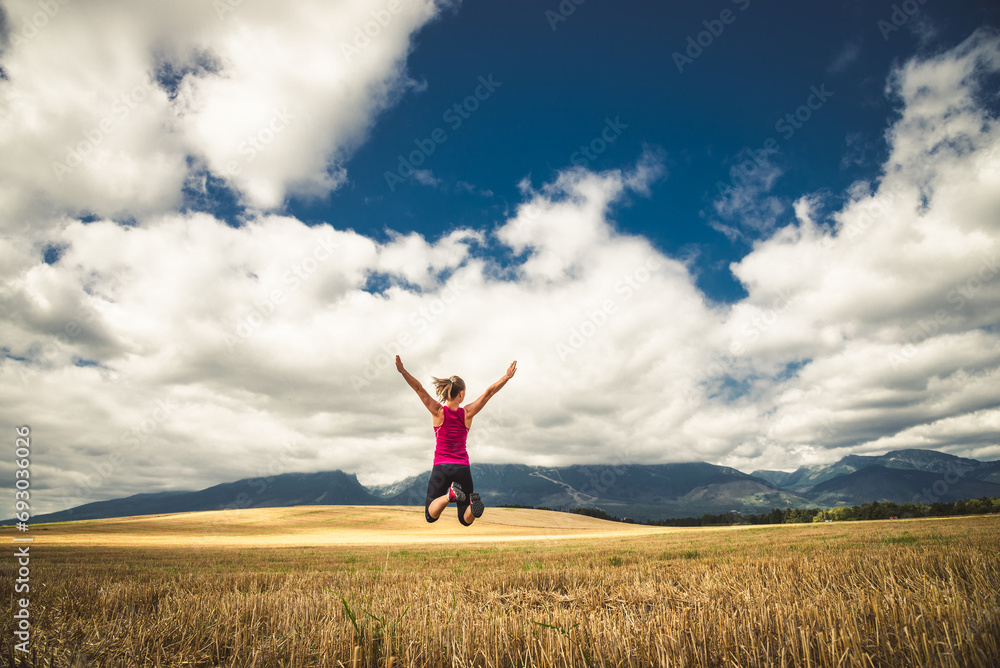 Young woman jumping in the mountains Young woman jumping in the mountains