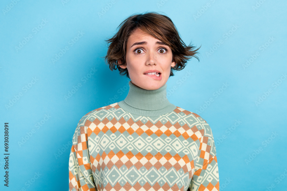 Portrait of impressed terrified horrified lady biting lips nervous staring isolated on blue color background Portrait of impressed terrified horrified lady biting lips nervous staring isolated on blue color background