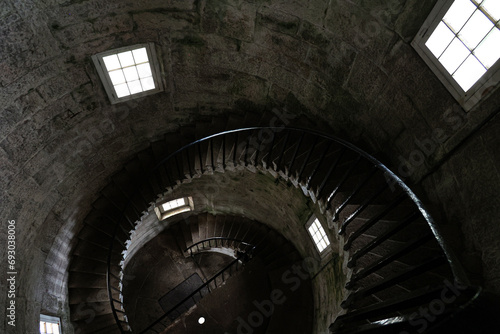 A stone spiral staircase viewed from the top