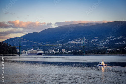 Luxury cruiseship cruise ship liner Summit arrival sail into port of Vancouver, BC Canada from Alaska Last Frontier adventure cruising during sunrise with beautiful scenic view	