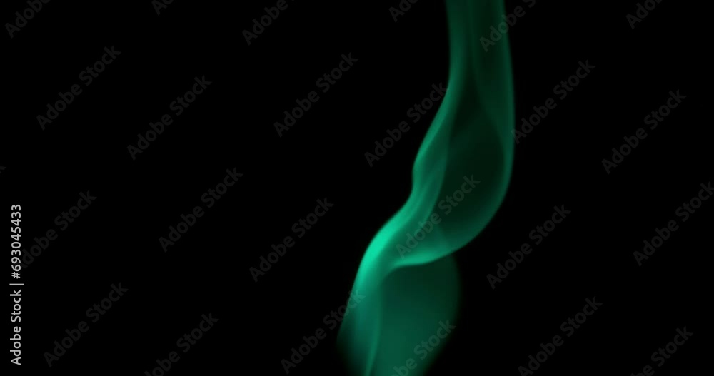 Natural smoke with green emerald backlight on a black background Natural smoke with green emerald backlight on a black background