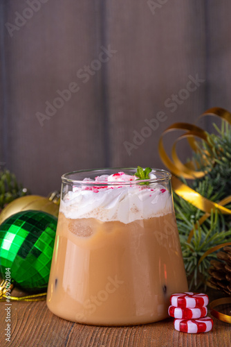 Iced Peppermint Mocha or Latte, Christmas coffee drink with crushed candy canes, whipped cream and mint syrup, festive holiday cold drink 