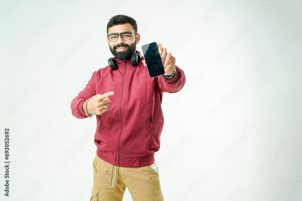 stylish men in jackets, sporting sunglasses, multitasking with headphones and a phone in hand, stylish men in jackets, sporting sunglasses, multitasking with headphones and a phone in hand,