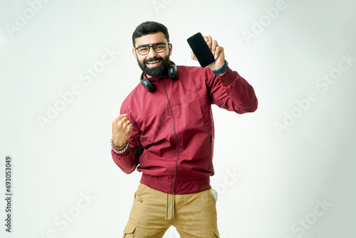 stylish men in jackets, sporting sunglasses, multitasking with headphones and a phone in hand,