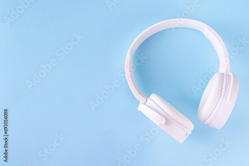 Sound Therapy Mental Health and Wellness concept. Light blue background with laptop and headphones top view flat lay copy space