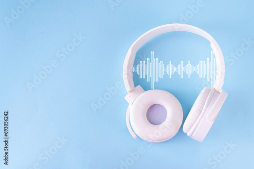 Sound Therapy Mental Health and Wellness concept. Light blue background with laptop and headphones top view flat lay copy space