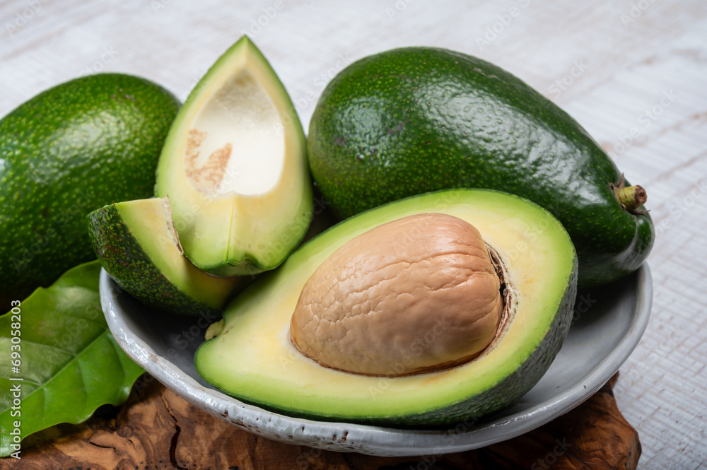 Green ripe avocado fruits from organic avocado plantation - healthy food Green ripe avocado fruits from organic avocado plantation - healthy food