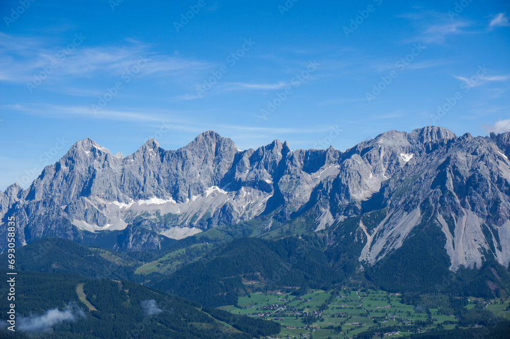 Amazing view to Dachstein mountain range in Styria near Ramsau Schladming on a sunny day with a clear blue sky and copy space for text