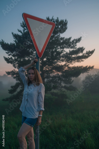 Woman in a field with misty...