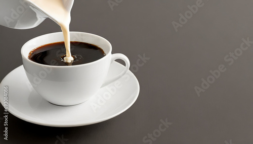 Coffee pouring into a cup with coffee beans on a gray background