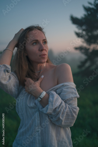 Woman in a field with misty...