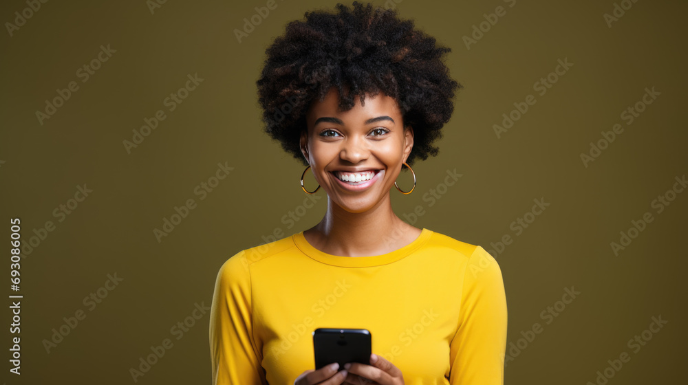 Young woman smiling and holding her smartphone on a colored background Young woman smiling and holding her smartphone on a colored background