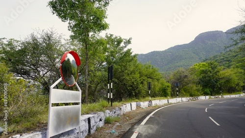 Outdoor traffic convex mirror in the hairpin bends and uphill road enroute to kodaikanal hilltop photo