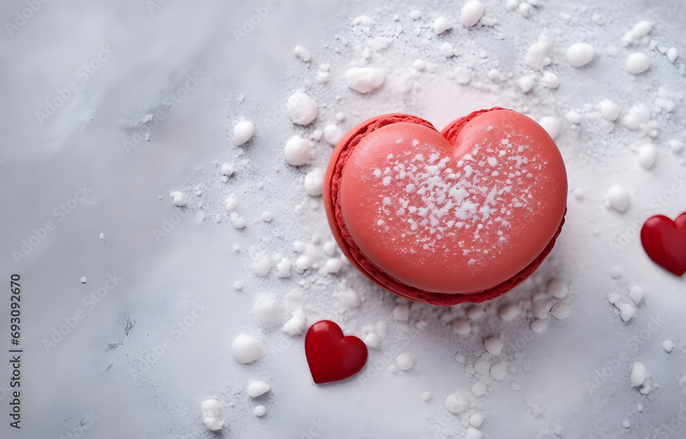 Fototapeta premium red heart shape macaron cookie on grey snowy background top view