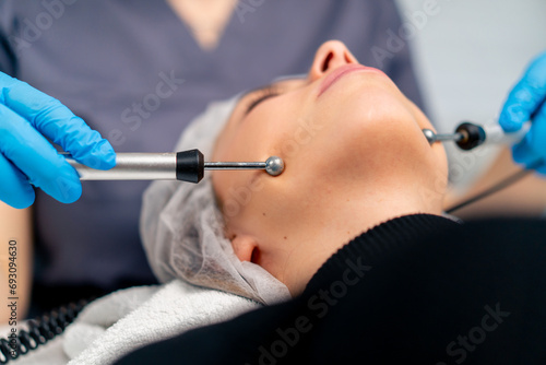 close-up of a beautician doctor massaging the skin of a client s face during a beauty and health cosmetic procedure